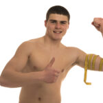 vecteezy male model with great body measuring his body with measuring 16677388